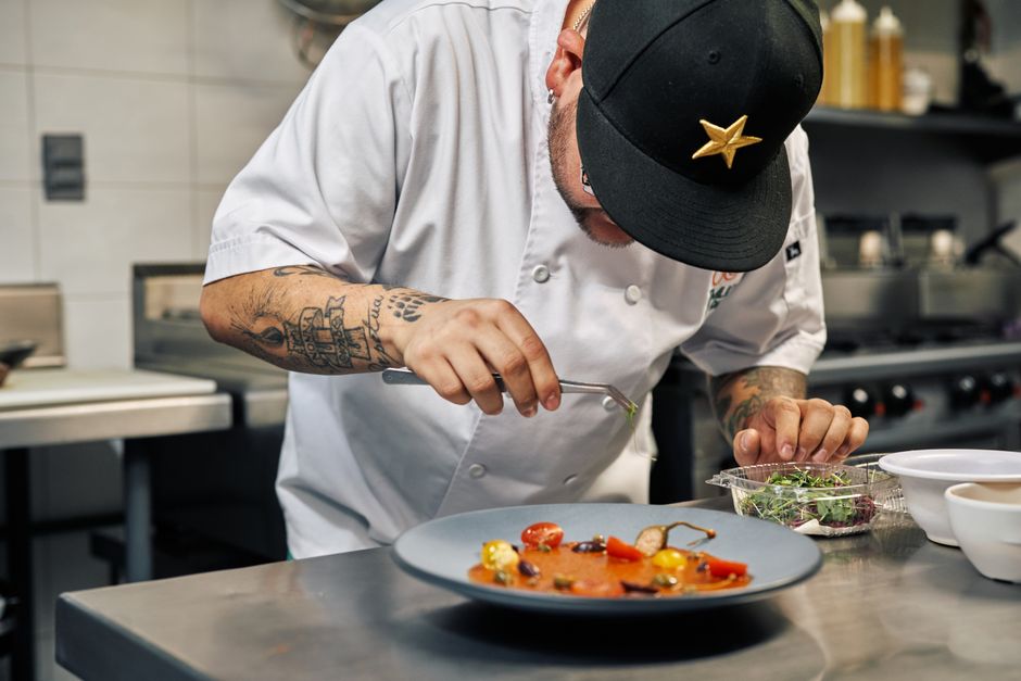 Professional chef plating gourmet food for a catered event